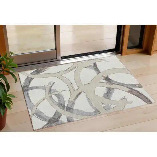 Ivory Gray And Beige Abstract Washable Indoor Outdoor Area Rug Photo 1