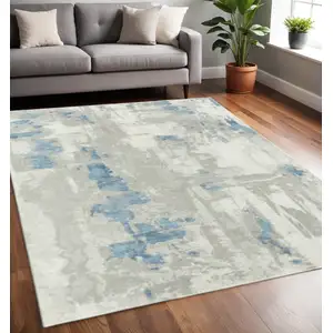 Photo of Ivory Gray And Blue Abstract Power Loom Stain Resistant Area Rug