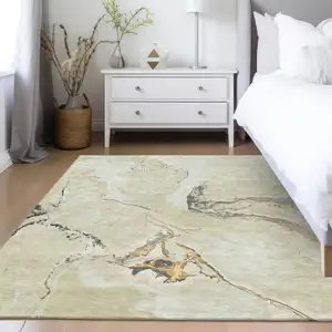 Photo of Ivory Gray And Gold Abstract Washable Indoor Outdoor Area Rug