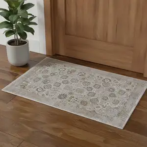 Photo of Ivory Gray And Gold Floral Area Rug With Fringe