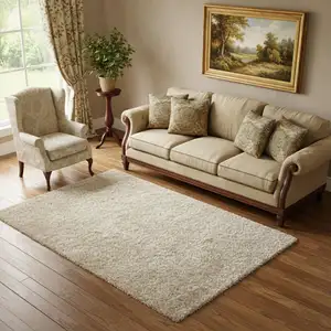 Photo of Ivory Gray And Gold Floral Area Rug With Fringe