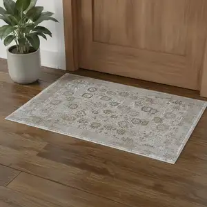 Photo of Ivory Gray And Gold Floral Area Rug With Fringe