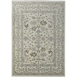 Photo of Ivory Gray and Brown Wool Floral Hand Knotted Area Rug With Fringe