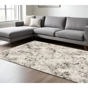 Photo of Ivory Grey Black Beige And Tan Abstract Power Loom Stain Resistant Area Rug