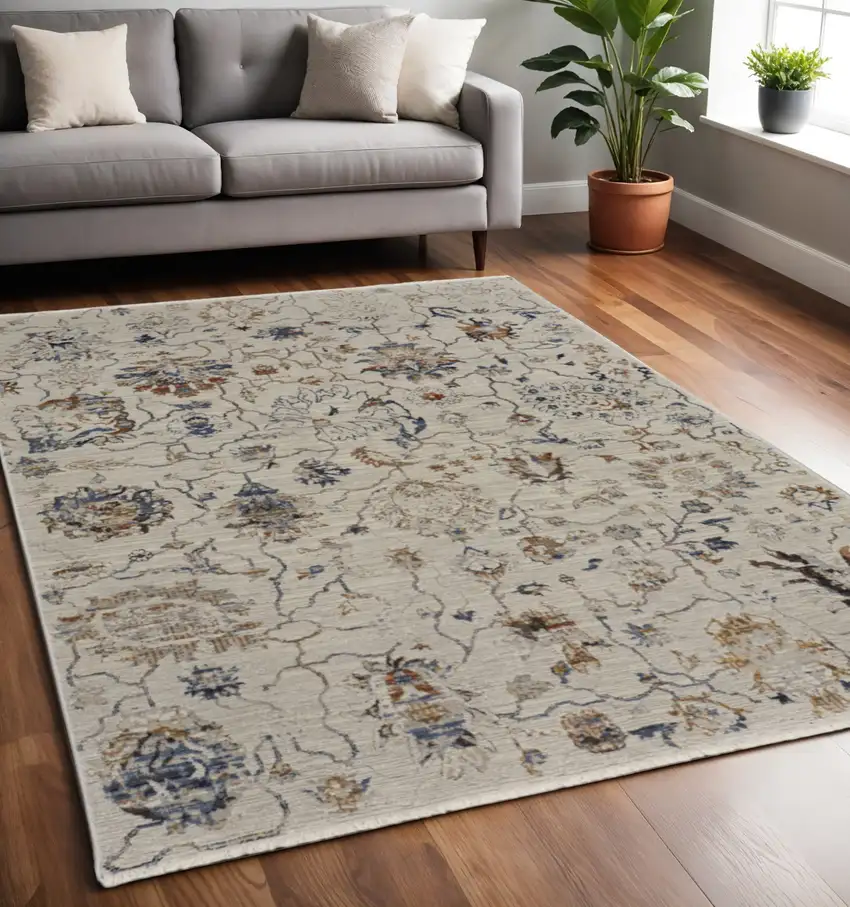 Ivory and Blue Floral Power Loom Distressed Non Skid Area Rug With Fringe Photo 1