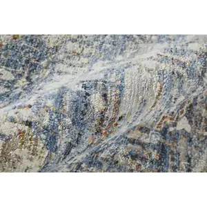 Photo of Ivory Orange And Blue Floral Power Loom Distressed Area Rug With Fringe