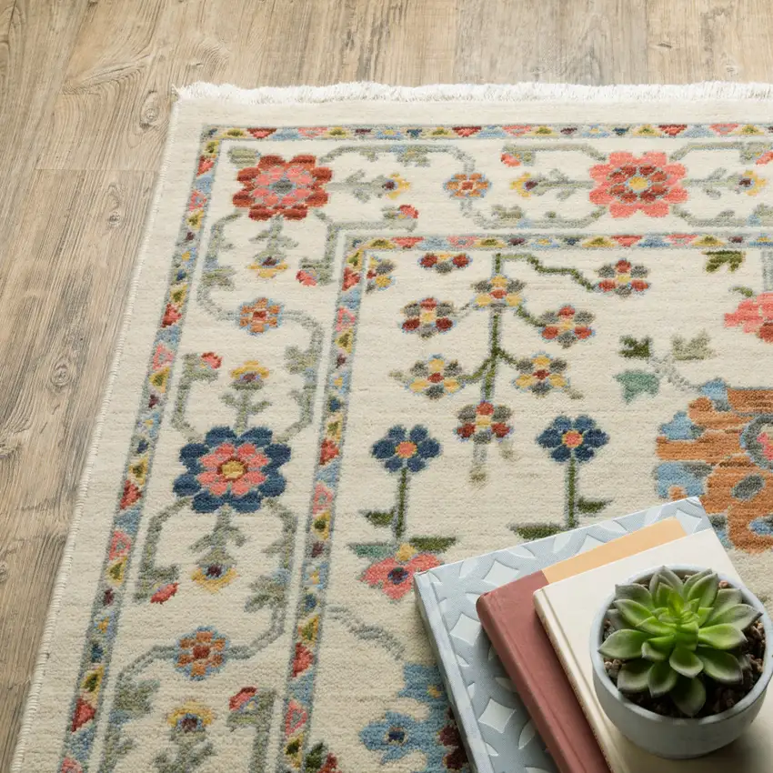 6' X 9' Ivory Salmon Pink Gold Blues Grey Rust And Green Oriental Power Loom Stain Resistant Area Rug With Fringe Photo 9