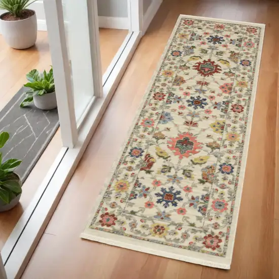 2' X 6' Ivory Salmon Pink Gold Blues Grey Rust And Green Oriental Power Loom Stain Resistant Runner Rug With Fringe Photo 1