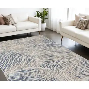 Photo of Ivory Tan And Blue Abstract Area Rug