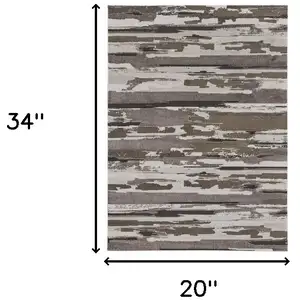 Photo of Ivory Tan And Brown Abstract Power Loom Distressed Stain Resistant Area Rug