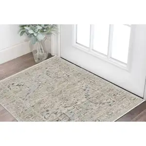Photo of Ivory Tan And Light Blue Oriental Distressed Area Rug With Fringe
