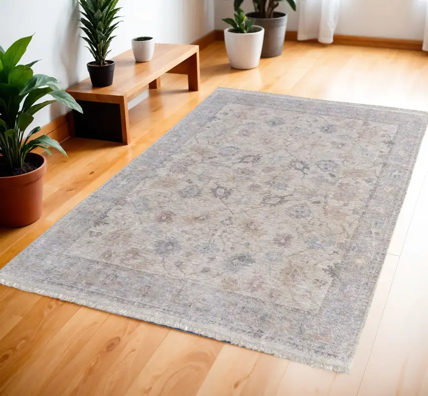 Ivory Tan and Blue Floral Hand Woven Distressed Area Rug With Fringe Photo 1