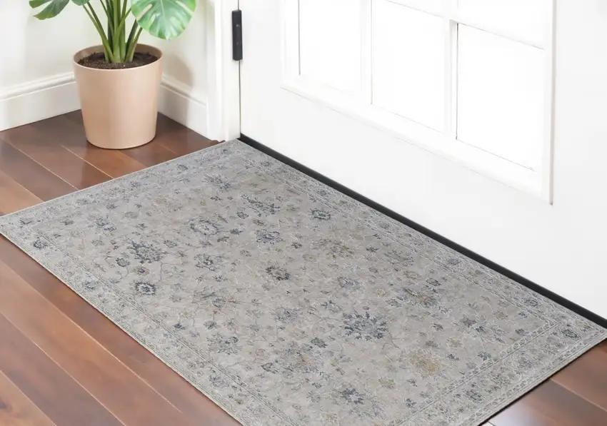 Ivory Taupe and Blue Floral Power Loom Worn Faded Area Rug With Fringe Photo 1