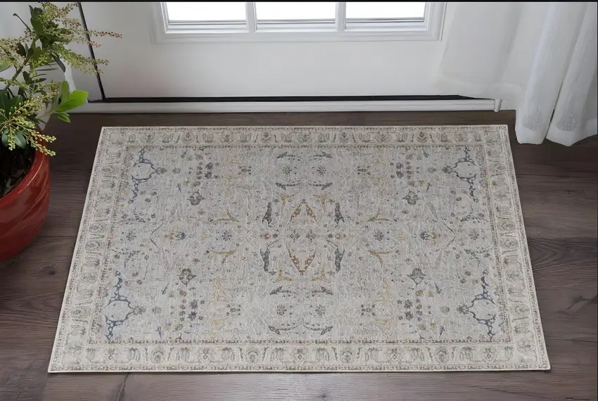 Ivory Taupe and Blue Ikat Power Loom Worn Faded Area Rug With Fringe Photo 1