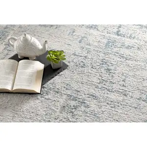 Photo of Ivory and Blue Abstract Distressed Area Rug
