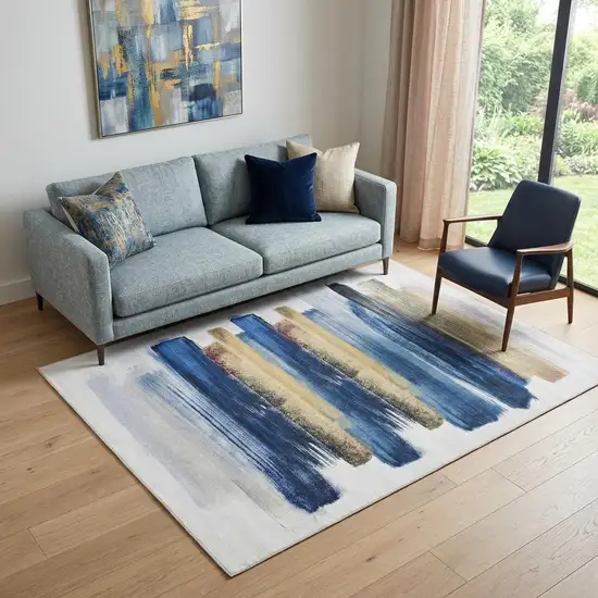 5' X 7' Ivory and Blue Abstract Power Loom Washable Non Skid Area Rug Photo 1