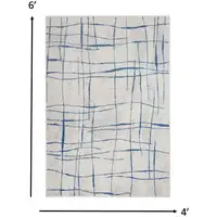 Photo of Ivory and Blue Irregular Grids Area Rug