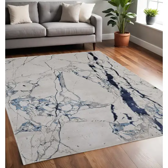 Ivory and Blue Marble Power Loom Distressed Area Rug Photo 1