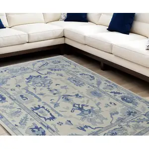 Photo of Ivory and Blue Wool Floral Hand Knotted Area Rug With Fringe