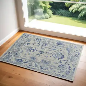 Photo of Ivory and Blue Wool Floral Hand Knotted Area Rug With Fringe