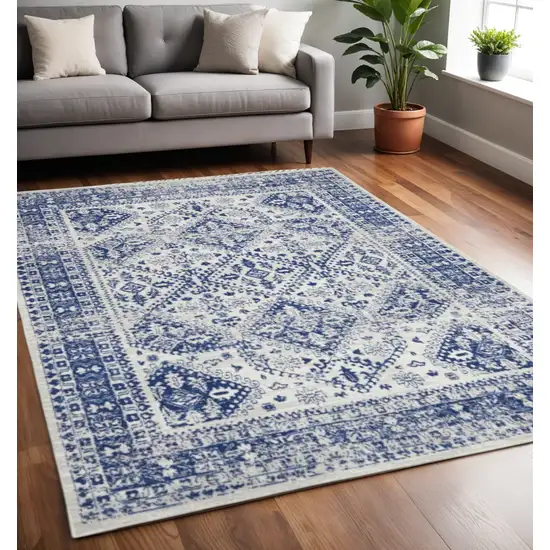 Ivory And Blue Geometric Distressed Area Rug Photo 1
