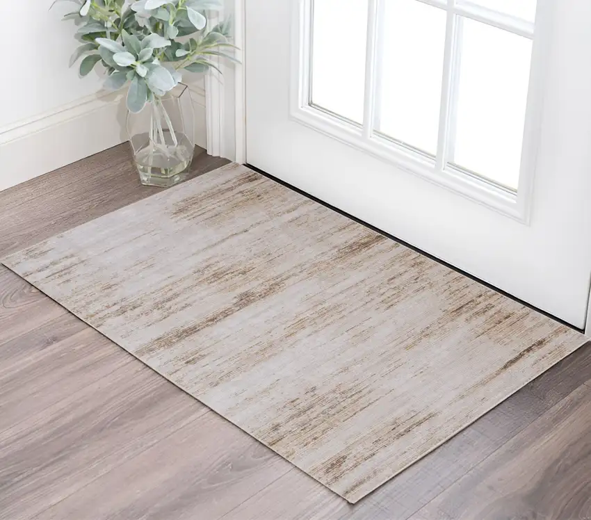 Ivory and Tan Abstract Power Loom Worn Faded Area Rug Photo 1