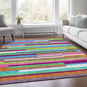 Photo of Lavender Orange And Lime Green Striped Washable Area Rug With UV Protection