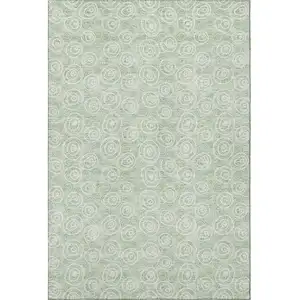 Photo of Mint Green And Ivory Polka Dot Washable Area Rug With UV Protection