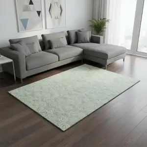 Photo of Mint Green And Ivory Polka Dot Washable Area Rug With UV Protection