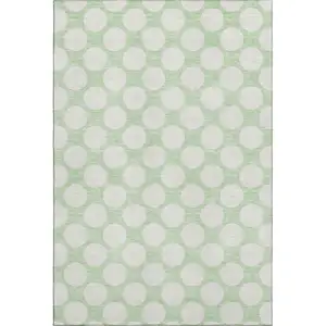 Photo of Mint Green And Ivory Polka Dot Washable Area Rug With UV Protection