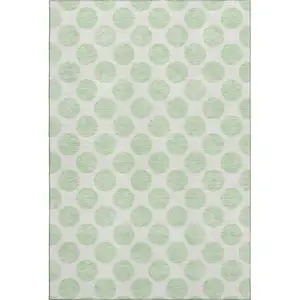 Photo of Mint Green And Ivory Polka Dot Washable Area Rug With UV Protection