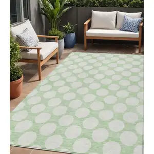 Photo of Mint Green And Ivory Polka Dot Washable Indoor Outdoor Area Rug