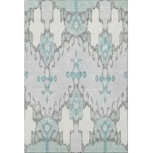 Photo of Mint Green Blue And Ivory Ikat Washable Area Rug With UV Protection