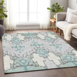 Photo of Mint Green Blue And Ivory Ikat Washable Area Rug With UV Protection