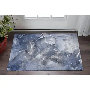 Photo of Navy Blue And Ivory Abstract Washable Area Rug With UV Protection