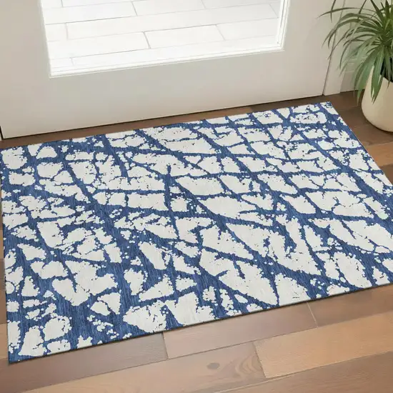 Navy Blue And Ivory Abstract Washable Area Rug With UV Protection Photo 1