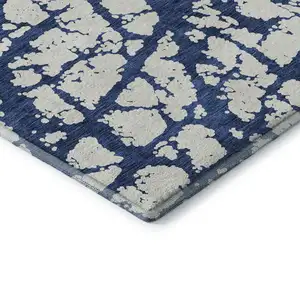 Photo of Navy Blue And Ivory Abstract Washable Area Rug With UV Protection