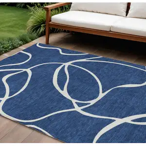 Photo of Navy Blue And Ivory Abstract Washable Indoor Outdoor Area Rug