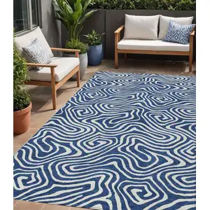 Photo of Navy Blue And Ivory Abstract Washable Indoor Outdoor Area Rug