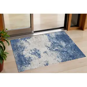Photo of Navy Blue And Ivory Abstract Washable Indoor Outdoor Area Rug