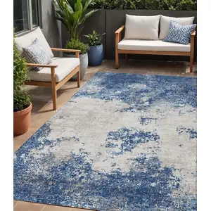 Photo of Navy Blue And Ivory Abstract Washable Indoor Outdoor Area Rug