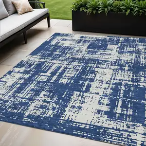 Photo of Navy Blue And Ivory Abstract Washable Indoor Outdoor Area Rug