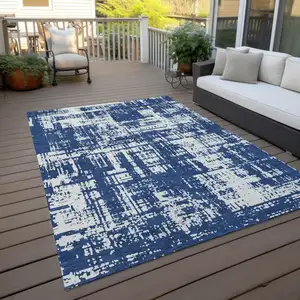 Photo of Navy Blue And Ivory Abstract Washable Indoor Outdoor Area Rug
