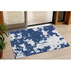 Photo of Navy Blue And Ivory Abstract Washable Indoor Outdoor Area Rug