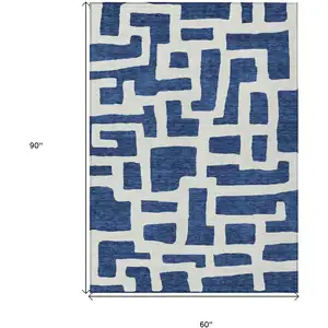 Photo of Navy Blue And Ivory Abstract Washable Indoor Outdoor Area Rug