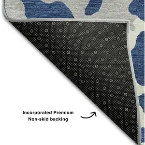 Photo of Navy Blue And Ivory Animal Print Washable Area Rug With UV Protection
