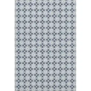 Photo of Navy Blue And Ivory Geometric Washable Area Rug With UV Protection