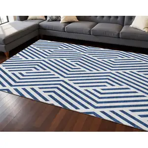 Photo of Navy Blue And Ivory Geometric Washable Area Rug With UV Protection