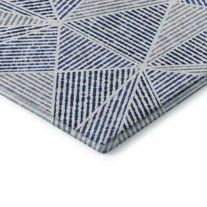 Photo of Navy Blue And Ivory Geometric Washable Area Rug With UV Protection