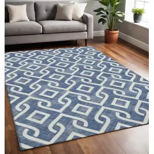 Photo of Navy Blue And Ivory Geometric Washable Area Rug With UV Protection
